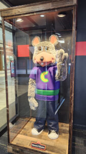Chuck E. Cheese mascot in a glass case at Chuck's Arcade in Buford, GA