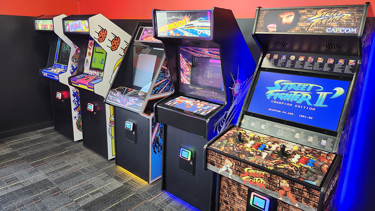 Row of classic arcade games at Chuck's Arcade in Buford, GA